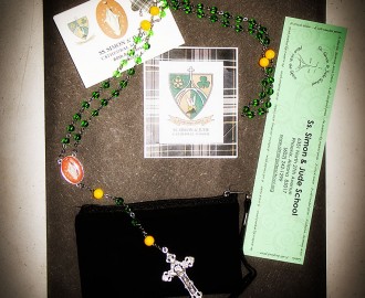 The welcome packet from SSJ Cathedral School, including folder of info, bookmark, and a beautiful rosary and booklet commemorating the 60th anniversary of the school.